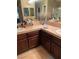 Bathroom features a double sink vanity, mirror and tile countertops at 9022 Sosa Creek Ave, Las Vegas, NV 89149