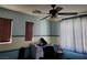 Bedroom with neutral walls, two windows with wood blinds, and a ceiling fan at 9022 Sosa Creek Ave, Las Vegas, NV 89149