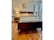 Bedroom features a queen-sized bed and wooden floors at 9022 Sosa Creek Ave, Las Vegas, NV 89149