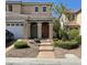 Charming exterior view of a two-story home with a well-manicured front yard and a welcoming entrance at 9022 Sosa Creek Ave, Las Vegas, NV 89149