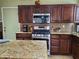 Kitchen features granite countertops and stainless steel appliances at 9022 Sosa Creek Ave, Las Vegas, NV 89149