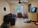 Cozy living room with comfortable seating, natural light, and charming home decor at 9022 Sosa Creek Ave, Las Vegas, NV 89149