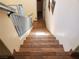 Staircase with tile steps, wooden rails and beige walls at 9022 Sosa Creek Ave, Las Vegas, NV 89149
