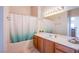 Clean bathroom with tub, vanity, and light wood cabinets at 9303 Gilcrease Ave # 2172, Las Vegas, NV 89149