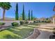 Backyard oasis featuring lush greenery, tall trees and a well-maintained lawn at 9843 Wonderful Day Dr, Las Vegas, NV 89148