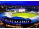 Night view of the Las Vegas Ballpark, home of the Aviators, in Summerlin, Nevada; with city skyline visible in the distance at 9843 Wonderful Day Dr, Las Vegas, NV 89148