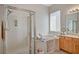 Bathroom with a walk-in shower, soaking tub, and a wood vanity with double sinks at 9843 Wonderful Day Dr, Las Vegas, NV 89148