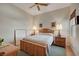 Comfortable bedroom features a wooden bed frame, bedside tables, and neutral decor at 9843 Wonderful Day Dr, Las Vegas, NV 89148