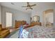 Spacious bedroom featuring hardwood floors, ceiling fan, and natural light from the sliding glass door at 9843 Wonderful Day Dr, Las Vegas, NV 89148