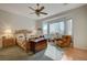 Bright bedroom with hardwood floor, ceiling fan, large window, and light colored walls at 9843 Wonderful Day Dr, Las Vegas, NV 89148
