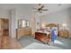 Light-filled bedroom features neutral walls, ceiling fan, hardwood floor, and three dressers at 9843 Wonderful Day Dr, Las Vegas, NV 89148