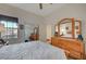 Bright bedroom features a large bed, and a wooden dresser with ample closet space at 9843 Wonderful Day Dr, Las Vegas, NV 89148
