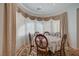 Bright dining area enhanced by decorative curtains and a chandelier, perfect for formal gatherings at 9843 Wonderful Day Dr, Las Vegas, NV 89148