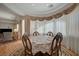 Elegant dining area with natural light and decorative drapes, perfect for entertaining at 9843 Wonderful Day Dr, Las Vegas, NV 89148