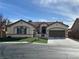 Charming single-story home with a well-manicured front yard and a two-car garage in a Gathering-friendly neighborhood at 9843 Wonderful Day Dr, Las Vegas, NV 89148