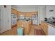 Charming kitchen with wood cabinets, a central island, and modern appliances at 9843 Wonderful Day Dr, Las Vegas, NV 89148
