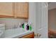 Functional laundry room with ample storage space, a utility sink, and durable countertops at 9843 Wonderful Day Dr, Las Vegas, NV 89148
