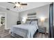 This bedroom features neutral walls, light gray wood-look flooring, and a ceiling fan at 2152 Quarry Ridge St # 106, Las Vegas, NV 89117