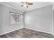 Minimalist bedroom with light grey walls, wood-look floors, and window at 2152 Quarry Ridge St # 106, Las Vegas, NV 89117