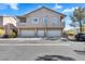 Contemporary townhome with three garage spaces, tan exterior, balconies, and minimal landscaping at 2152 Quarry Ridge St # 106, Las Vegas, NV 89117
