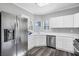 Bright kitchen featuring white cabinets, stainless steel appliances, and wood-look flooring at 2152 Quarry Ridge St # 106, Las Vegas, NV 89117