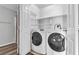 Laundry room featuring a white front load washer and dryer, with wire shelving at , Las Vegas, NV 89117