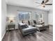 Comfortable living room featuring grey sectional sofa, wood-look floors, and a ceiling fan at 2152 Quarry Ridge St # 106, Las Vegas, NV 89117