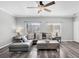 Stylish living room featuring a grey sofa, wood-look floors, and plenty of natural light at 2152 Quarry Ridge St # 106, Las Vegas, NV 89117