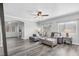 Open-concept living room with grey wood floors, sectional sofa, and lots of natural light at 2152 Quarry Ridge St # 106, Las Vegas, NV 89117
