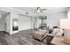 Spacious living room with wood-look floors, modern furniture, and natural light at 2152 Quarry Ridge St # 106, Las Vegas, NV 89117