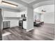 Open concept kitchen and living room features stainless steel appliances and wood-look flooring at 2152 Quarry Ridge St # 106, Las Vegas, NV 89117