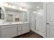 Bathroom with double vanity, white subway tile, and glass shower at 10328 Apefly St, Las Vegas, NV 89141