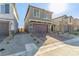 Two-story house with brown garage door and brick paver driveway at 10328 Apefly St, Las Vegas, NV 89141