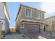 Two-story house with brown garage door and brick paver driveway at 10328 Apefly St, Las Vegas, NV 89141