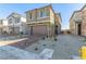 Two-story house with brown garage door and brick paver driveway at 10328 Apefly St, Las Vegas, NV 89141