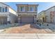 Two-story house with brown garage door and brick paver driveway at 10328 Apefly St, Las Vegas, NV 89141