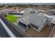 Aerial view of backyard featuring outdoor patio, BBQ, lush lawn and a tennis court for recreation at 10420 Luella Ct, Las Vegas, NV 89143