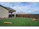 Spacious backyard featuring a synthetic lawn, desert landscaping, and corn hole game at 10420 Luella Ct, Las Vegas, NV 89143