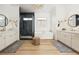 Elegant bathroom featuring a glass shower, soaking tub, and dual vanities with wood-look floors and modern fixtures at 10420 Luella Ct, Las Vegas, NV 89143