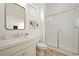 Bright bathroom with a glass-enclosed shower, framed mirror, and white vanity at 10420 Luella Ct, Las Vegas, NV 89143