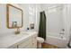 Well-lit bathroom featuring a bathtub-shower combo, stylish vanity with a stone countertop, and modern finishes at 10420 Luella Ct, Las Vegas, NV 89143