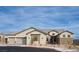 Charming single-story home features a three-car garage and inviting stone accents, set beneath a clear blue sky at 10420 Luella Ct, Las Vegas, NV 89143