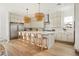 Modern kitchen with a large island, stainless steel appliances, and custom light fixtures at 10420 Luella Ct, Las Vegas, NV 89143