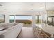 Bright living room with a white couch, backyard view, dining table and modern finishes at 10420 Luella Ct, Las Vegas, NV 89143