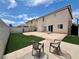 Spacious backyard featuring a concrete patio, artificial grass, and secure fencing at 10618 Timber Stand St, Las Vegas, NV 89183