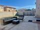 Comfortable backyard featuring stylish patio furniture, a privacy wall, and a well-kept concrete slab at 10618 Timber Stand St, Las Vegas, NV 89183