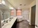 Bathroom featuring double sinks, soaking tub, and glass shower at 10618 Timber Stand St, Las Vegas, NV 89183