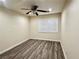 Bedroom featuring wood floors, a ceiling fan, and a window with white shutters at 10618 Timber Stand St, Las Vegas, NV 89183