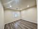Bedroom featuring wood floors and a window with white shutters at 10618 Timber Stand St, Las Vegas, NV 89183