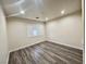 Bedroom featuring wood floors and a window with white shutters at 10618 Timber Stand St, Las Vegas, NV 89183